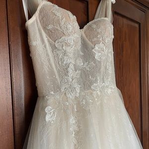 Brand new custom wedding dress . Size 10 . Only been worn to try on